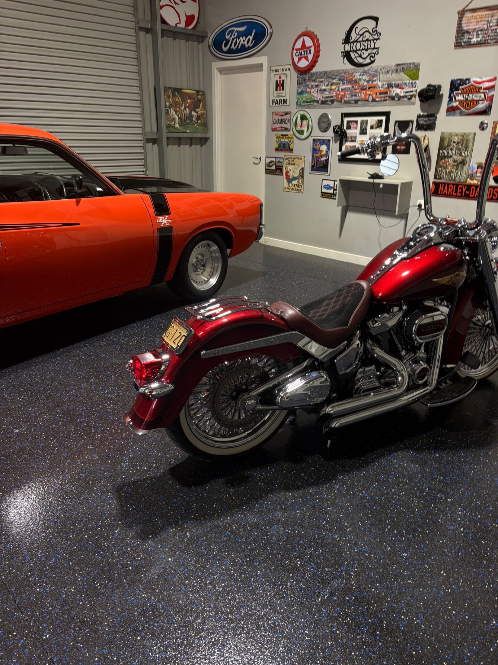 Metallic blue epoxy flake garage floor with a classic muscle car and motorcycle