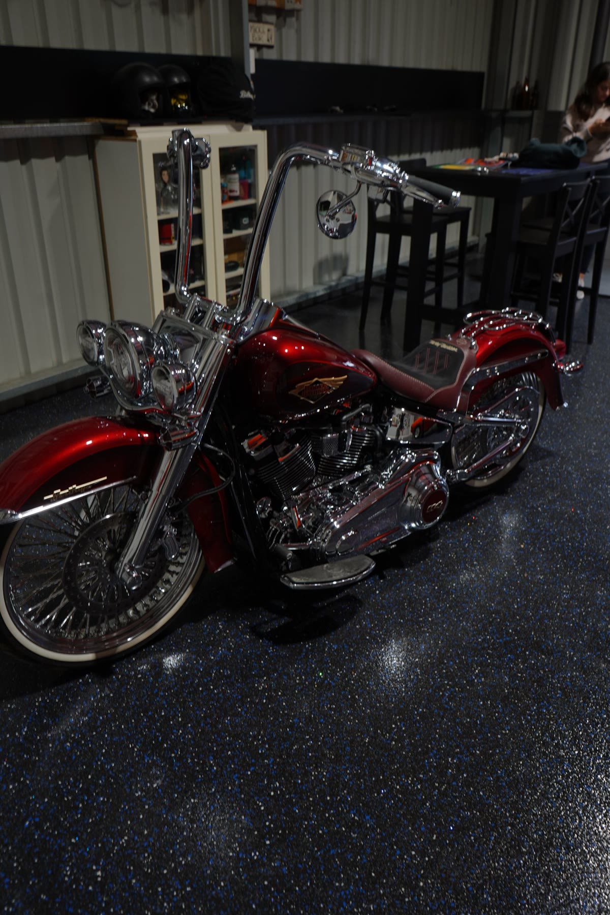 Blue metallic epoxy flake floor in a garage with a custom Harley