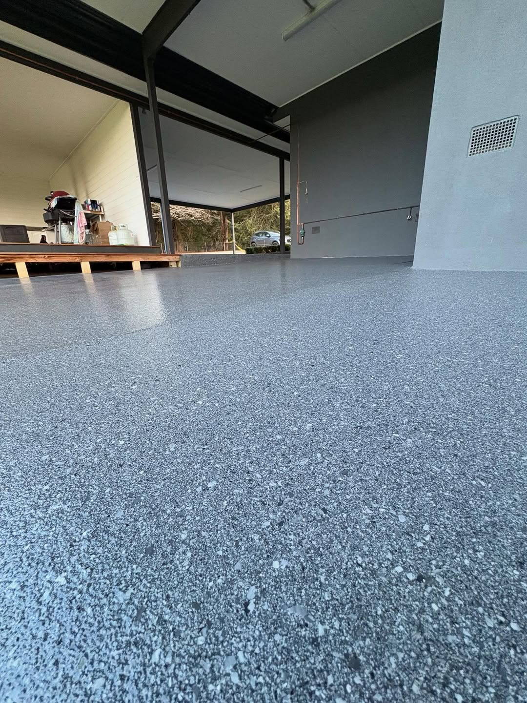 Grey epoxy flake floor on an alfresco patio and home surround