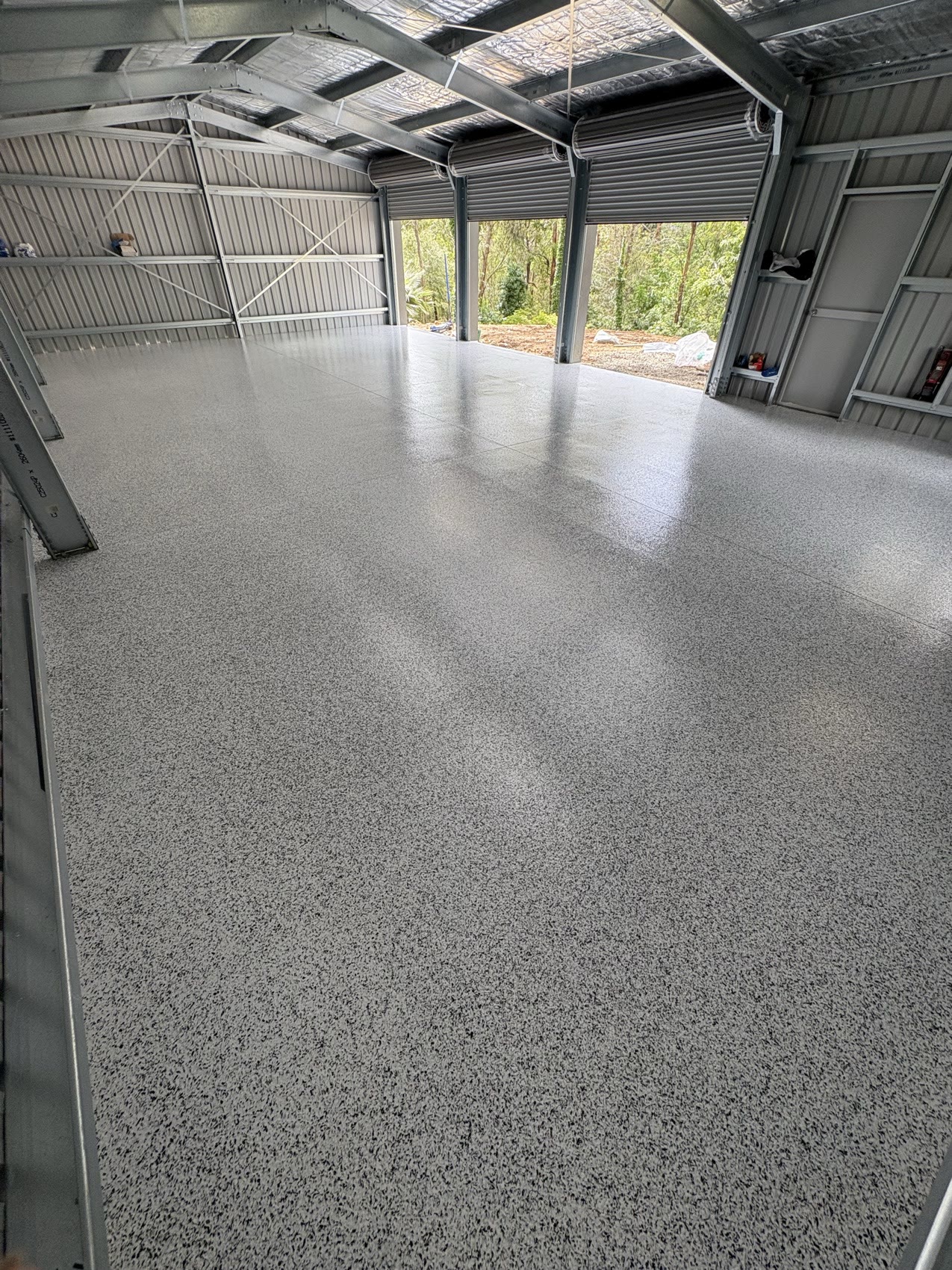 Large shed and carport with light grey epoxy flake flooring
